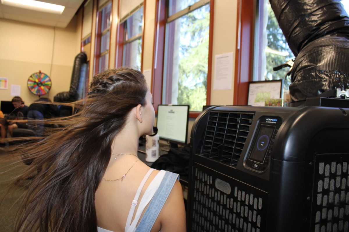 Josie Jackson, freshman, attempts to cool off in front of one of the temporary AC units in the art building.  